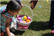 Girl Picking up an Easter Egg