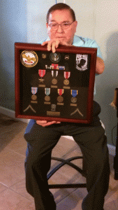 Tony Becerra Holding War Badges of Honor
